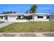 Charming single story home with a well manicured lawn, white exterior, and a single car garage at 10047 41St N St # 10047, Pinellas Park, FL 33782