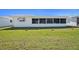 Charming home featuring a well-maintained lawn and a screened-in sunroom at 10047 41St N St # 10047, Pinellas Park, FL 33782