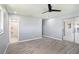 Open living area showcasing modern flooring and access to a stylish bathroom with sleek fixtures at 10047 41St N St # 10047, Pinellas Park, FL 33782