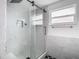 Modern bathroom featuring a glass-enclosed shower with rainfall shower head and niche at 10206 Wexford Ct, Tampa, FL 33615