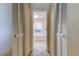 Hallway leading to a bathroom featuring a large bathtub and a window at 1034 Marco Ne Dr, St Petersburg, FL 33702