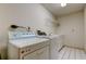 Bright laundry room featuring a washer, dryer, and storage space with tile floors at 1034 Marco Ne Dr, St Petersburg, FL 33702