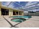 The pool area is covered by a white enclosure and includes a Jacuzzi at 1034 Marco Ne Dr, St Petersburg, FL 33702