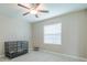 Simple bedroom with a large window and tiled floor at 10364 Alder Green Dr, Riverview, FL 33578