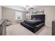 Main bedroom with tufted headboard, soft carpet, and a relaxing atmosphere at 10364 Alder Green Dr, Riverview, FL 33578