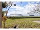 Charming backyard with a scenic view of the water, lush greenery, and a birdhouse at 1111 N Bayshore Blvd # F11, Clearwater, FL 33759