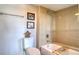 Bright bathroom featuring a tub with beige tile surround, complemented by elegant decor and natural light at 1111 N Bayshore Blvd # F11, Clearwater, FL 33759