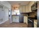 Well-lit kitchen featuring stainless steel appliances, custom cabinets, and granite countertops at 1111 N Bayshore Blvd # F11, Clearwater, FL 33759