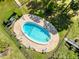 Aerial view of an inviting pool area with lounge chairs, manicured landscaping, and privacy fencing at 1111 N Bayshore Blvd # F11, Clearwater, FL 33759