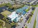 Aerial view of community pool, tennis courts, and pond at 1154 Kennewick Ct, Wesley Chapel, FL 33543