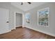 This bedroom features two windows, wood floors, closet and neutral walls at 1154 Kennewick Ct, Wesley Chapel, FL 33543