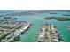 Aerial view of a waterfront community, showcasing the neighborhood's waterways, boat docks, and coastal views at 12055 3Rd E St # 103, Treasure Island, FL 33706