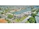 Aerial image of a waterfront neighborhood showing access to the Gulf, lush landscaping, and condominium buildings at 12055 3Rd E St # 103, Treasure Island, FL 33706