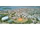 Aerial view of a waterfront community, showcasing the neighborhood's amenities with coastal views and a baseball field nearby at 12055 3Rd E St # 103, Treasure Island, FL 33706
