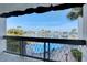 Balcony view of sparkling waterway, boats and beautiful landscaping with a large pool at 12055 3Rd E St # 103, Treasure Island, FL 33706