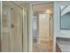 Bathroom featuring glass-door shower and view to closet and bedroom beyond at 12055 3Rd E St # 103, Treasure Island, FL 33706