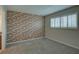 Cozy bedroom with brick accent wall and natural light at 12055 3Rd E St # 103, Treasure Island, FL 33706