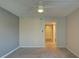 This empty bedroom features neutral carpeting, a closet view, and an overhead fan at 12055 3Rd E St # 103, Treasure Island, FL 33706