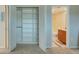 A view of a closet with built-in shelving shows a bathroom through the doorway at 12055 3Rd E St # 103, Treasure Island, FL 33706