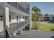 Clean condominium exterior featuring gated porches for each level of residents at 12055 3Rd E St # 103, Treasure Island, FL 33706