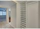 A hallway features a built-in closet with a view to the bedroom and bathroom at 12055 3Rd E St # 103, Treasure Island, FL 33706