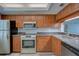 Modern kitchen with stainless appliances, granite counters, and wood cabinets at 12055 3Rd E St # 103, Treasure Island, FL 33706