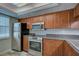 Well-equipped kitchen with stainless steel appliances and wood cabinetry at 12055 3Rd E St # 103, Treasure Island, FL 33706
