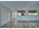 Spacious open-concept living room with wood flooring, a mirrored wall, and breakfast bar at 12055 3Rd E St # 103, Treasure Island, FL 33706