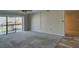 Spacious carpeted living room with access to balcony at 12055 3Rd E St # 103, Treasure Island, FL 33706