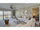 Inviting living room with a ceiling fan, sliding glass doors to a balcony, and neutral decor at 12055 3Rd E St # 103, Treasure Island, FL 33706