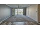 Large carpeted living room with sliding doors to a balcony that offers beautiful views at 12055 3Rd E St # 103, Treasure Island, FL 33706