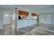 Spacious living area with wood floors, a breakfast bar, and an abundance of natural light at 12055 3Rd E St # 103, Treasure Island, FL 33706