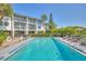 Relaxing pool with palm trees and lounge chairs in front of condo building at 12055 3Rd E St # 103, Treasure Island, FL 33706