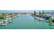 This photo showcases a waterfront canal with boats docked along it, and condominiums in the background at 12055 3Rd E St # 103, Treasure Island, FL 33706