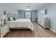 Serene bedroom showcasing a tufted headboard, crystal chandelier, and soft blue walls at 12310 Juniper Field Ct, Riverview, FL 33579