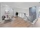 Cozy loft area with stylish furnishings, neutral decor, and staircase with metal railings at 12310 Juniper Field Ct, Riverview, FL 33579