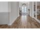 A light-filled foyer featuring wood-look tile flooring and a view of the front entry at 12516 Horseshoe Bend Dr, Lithia, FL 33547