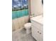 Bathroom with a white vanity, patterned tile flooring, and a shower featuring a beach themed curtain at 12760 Indian Rocks Rd # 1066, Largo, FL 33774