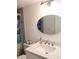 Bright bathroom featuring an oval mirror, vanity with chrome fixtures, and shower with a patterned shower curtain at 12760 Indian Rocks Rd # 1066, Largo, FL 33774