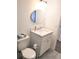 Cozy half-bath featuring a modern round mirror and patterned tile floor at 12760 Indian Rocks Rd # 1066, Largo, FL 33774