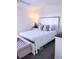 Comfortable bedroom featuring a well-dressed bed, nightstand, and ample space at 12760 Indian Rocks Rd # 1066, Largo, FL 33774