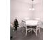 Bright dining area featuring a white table with four chairs and modern lighting fixture at 12760 Indian Rocks Rd # 1066, Largo, FL 33774