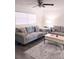 Comfortable living room with modern furniture, ceiling fan and a large window with bright, natural light at 12760 Indian Rocks Rd # 1066, Largo, FL 33774