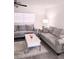 Cozy living room features modern gray sofas, a stylish rug, and a bright lamp for a welcoming atmosphere at 12760 Indian Rocks Rd # 1066, Largo, FL 33774