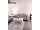 Comfortable living room features modern gray sofas, a stylish rug and a bright lamp for a welcoming atmosphere at 12760 Indian Rocks Rd # 1066, Largo, FL 33774