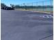 Paved parking lot with designated spaces next to a tennis court at 12760 Indian Rocks Rd # 1066, Largo, FL 33774