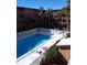 View of community pool with lounge chairs and palm trees in a multi-story building complex at 12760 Indian Rocks Rd # 1066, Largo, FL 33774