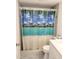 Close up of the shower with a beach themed curtain at 12760 Indian Rocks Rd # 1066, Largo, FL 33774