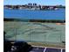 View of community tennis courts with kayaks and waterfront apartment complex at 12760 Indian Rocks Rd # 1066, Largo, FL 33774