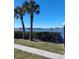 Serene water view with palm trees and lush hedges along the waterfront at 12760 Indian Rocks Rd # 1066, Largo, FL 33774